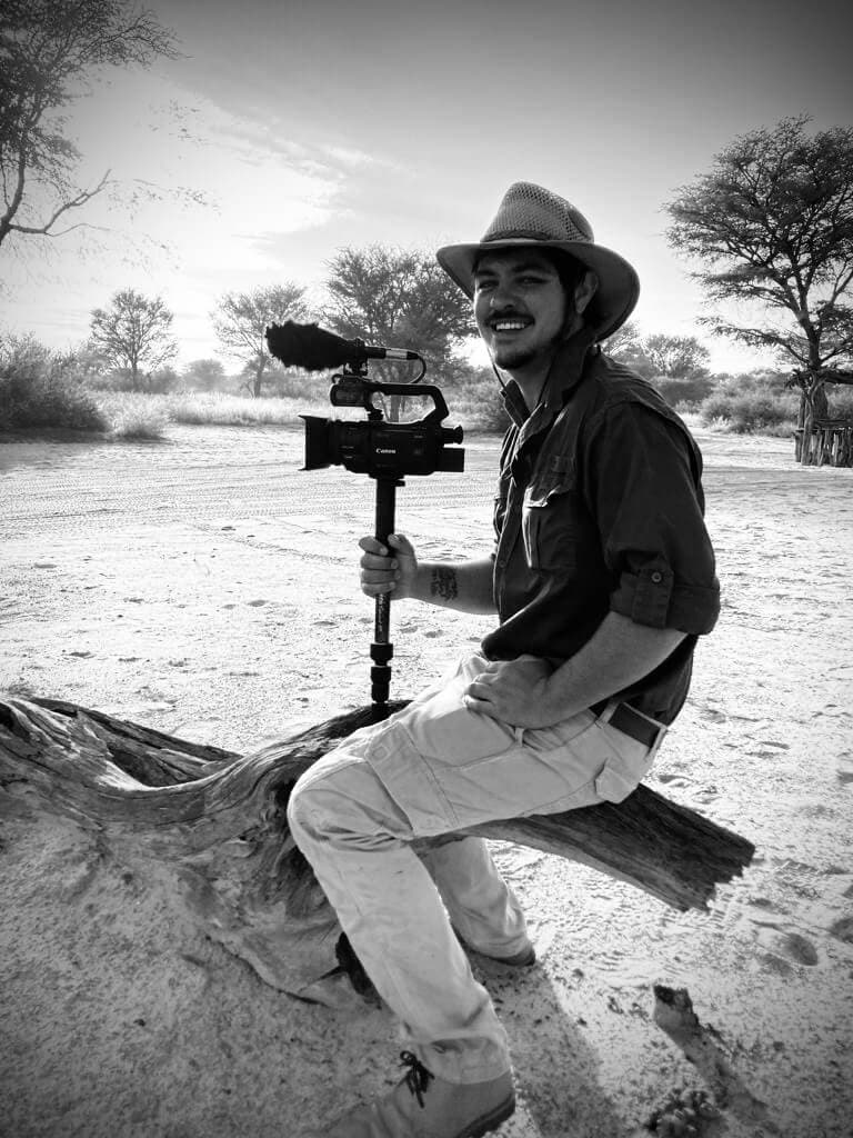 Rhys — founder and director of photography, holding a camera on a gimbal in the bush